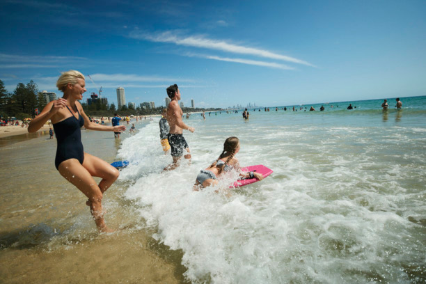 Family swimming at the beach