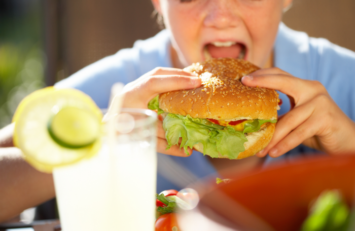 Girl eating a hamburger lunch